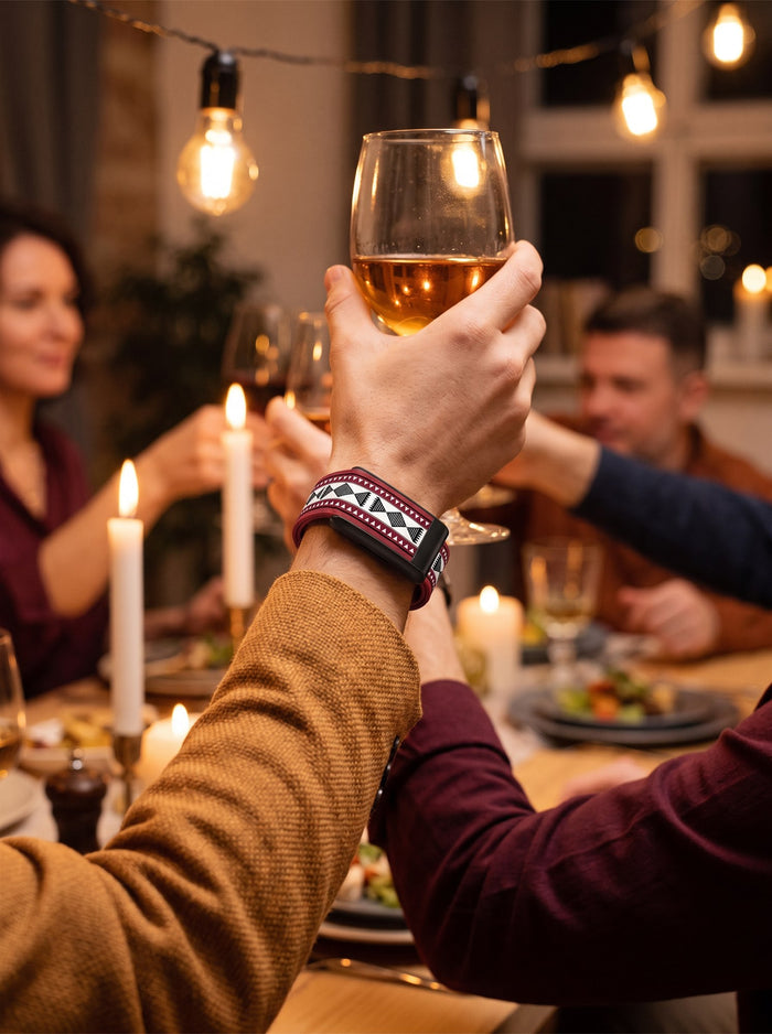 Dinner with friends wearing a patterned Strapion WHOOP band